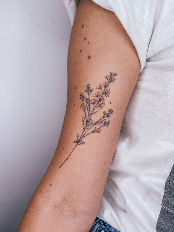 larkspur july birth flower tattoo design idea on upper inner arm for females