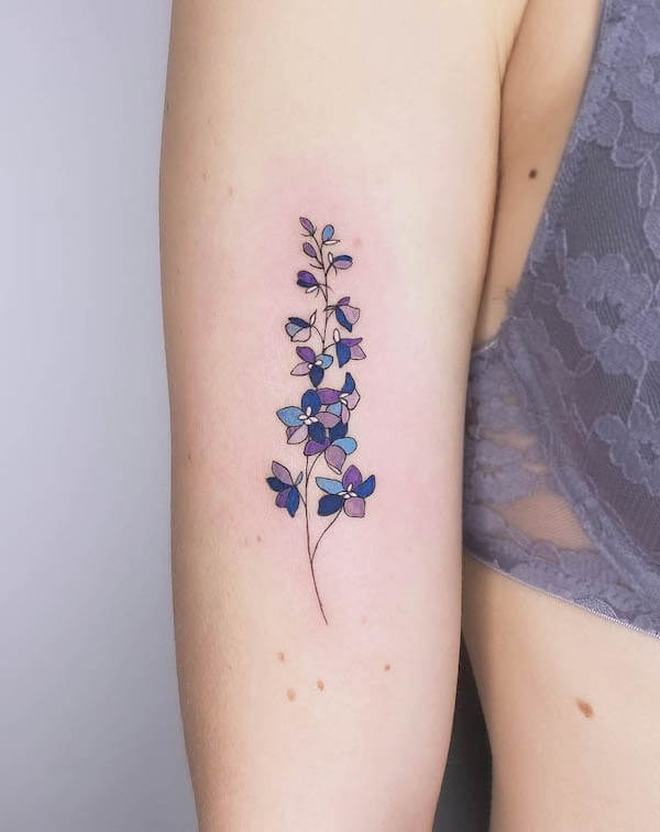 fine line minimalist larkspur july birth flower tattoo design idea for females