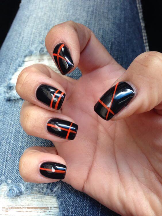 geometirc orange lines on black nail art design idea