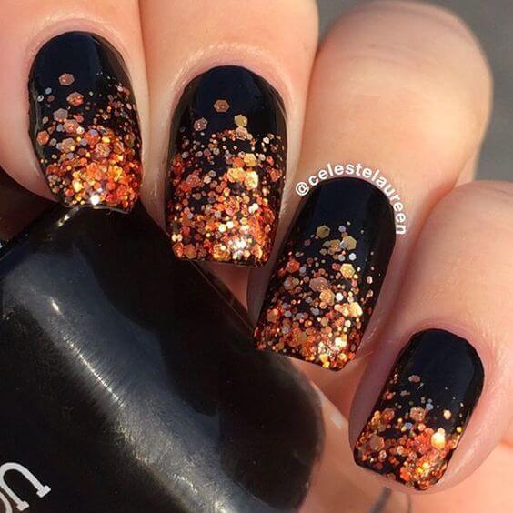 black with ornage glitter nail art design idea