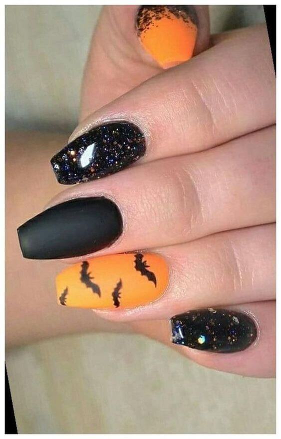 coffin with bats and glitter black and orange nail art design idea
