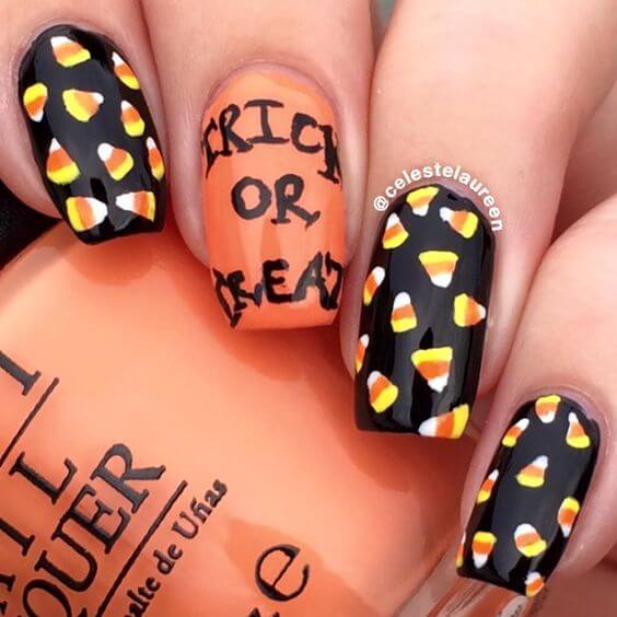 black and orange with candy corn halloween nail art design idea