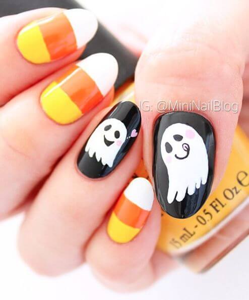 cute spooky ghost black with candy corn nail art design idea for halloween