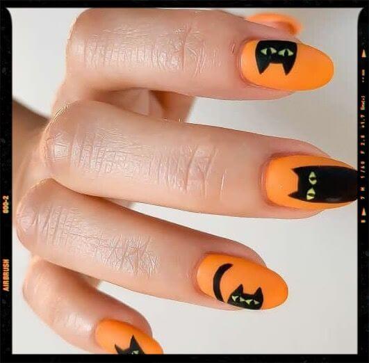 black cat on orange nail art design idea for halloween