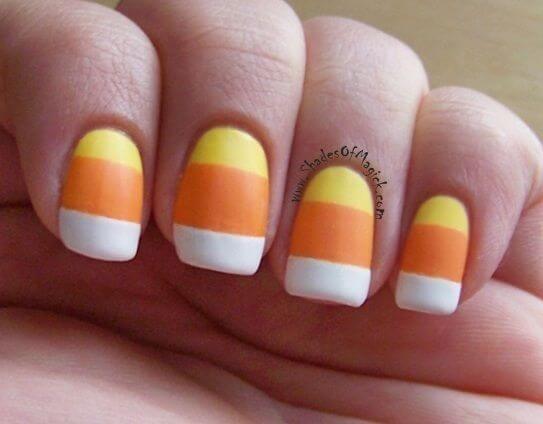 yellow orange and white candy corn nail art design idea