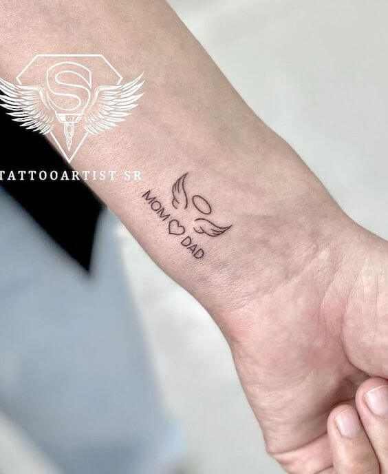 angel wings and heart design with mom dad tattoo on wrist