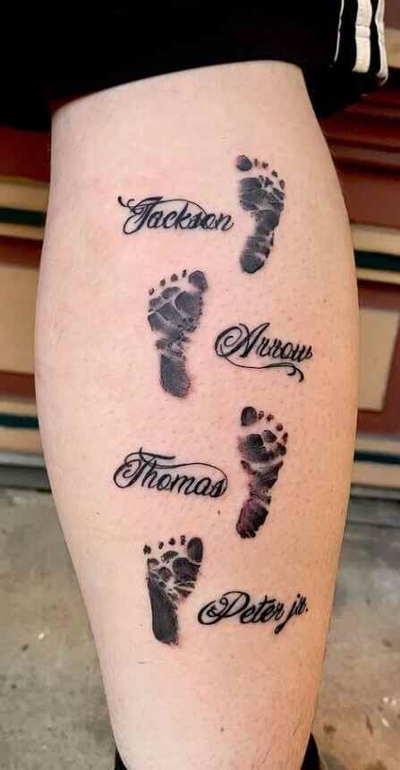foot prints with children names tattoo design on leg back
