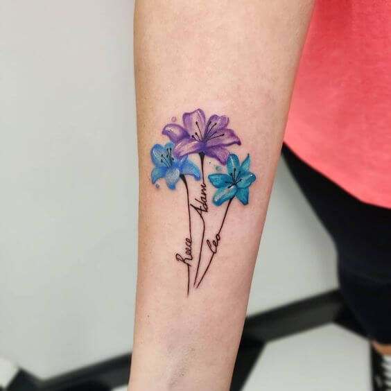 lily flowers with children name tattoo designs on wrist