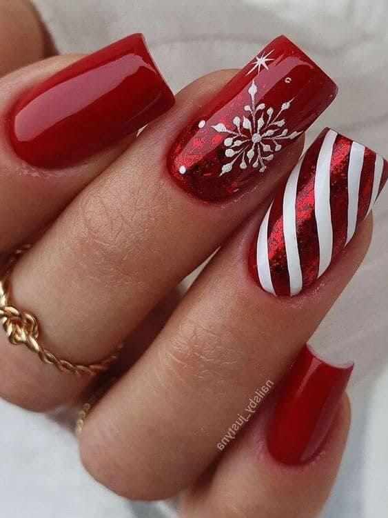 glossy red with snowflakes and candy cane stripes Christmas nail design