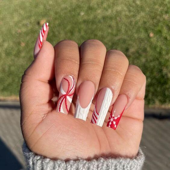 long acrylic snowflake and sweater pattern with candy cane nail art design