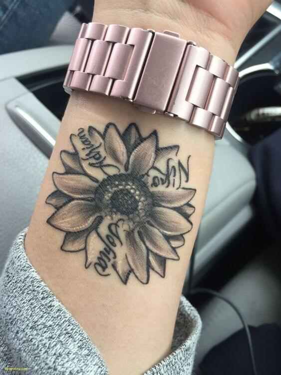 sunflower with children's name tattoo design on wrist
