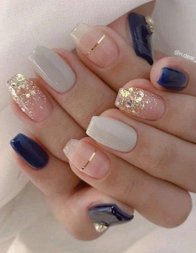 gold glitter and lines on transparent with navy blue fancy nails art designs