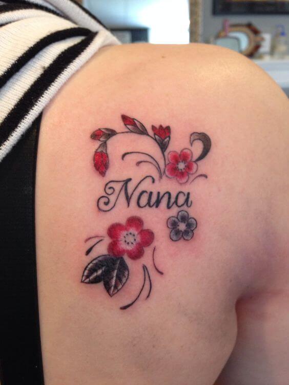 small flowers with granddaughter name tattoo design