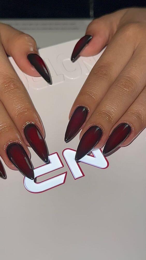 pointy vampire inspired maroon and black nails