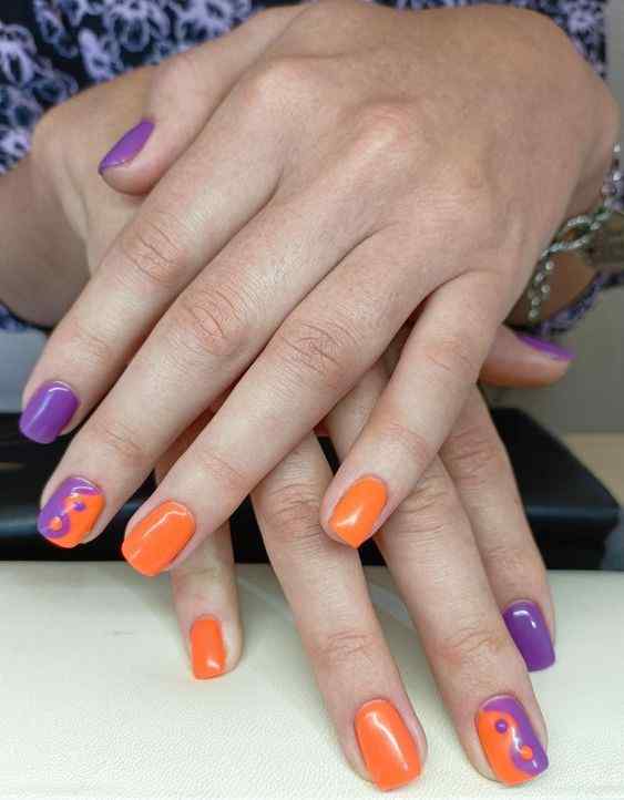 Ying Yang design orange and purple nails