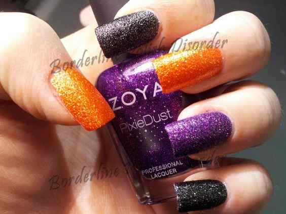glitter on black with orange and purple nails