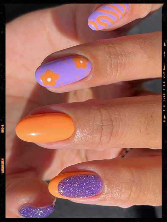 flowers and glitter orange and purple nails