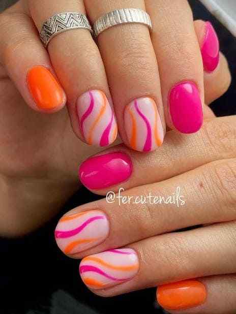 fun short swirls with orange and pink summer nails