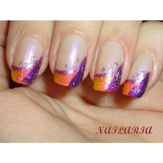 silver glitter designs on nude with yellow-orange and purple nails