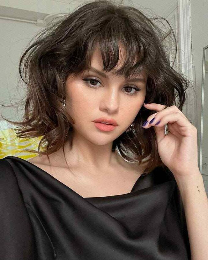 Selena Gomez short wavy layered shaggy bob with bangs hairstyle 