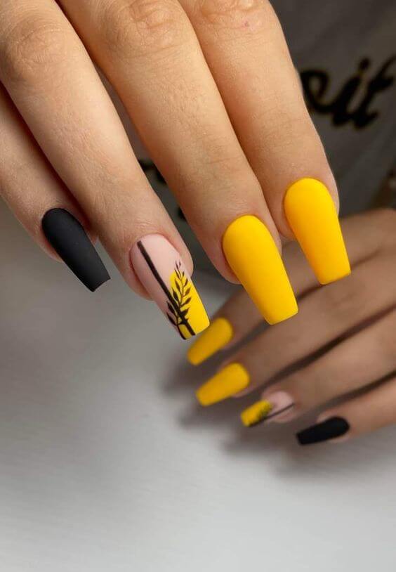 matte black and yellow with leaf nails art designs
