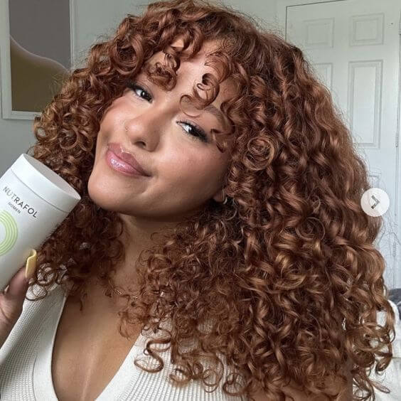 natural curly hair with red brown highlights