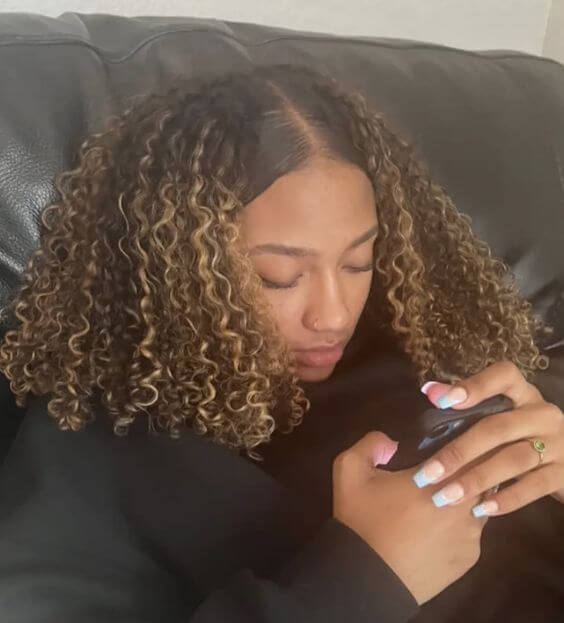 sleek natural curly hair with highlights