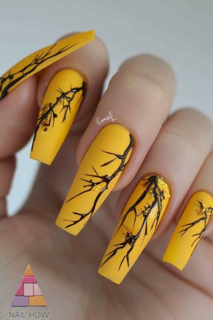 matte yellow with black tree branches nail art designs