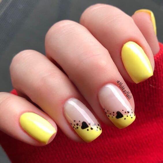 nude with yellow and black hearts with dots nail art designs
