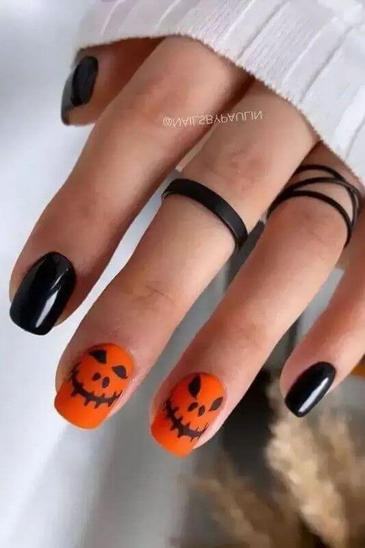 spooky pumpkin faces short black and orange halloween nail designs
