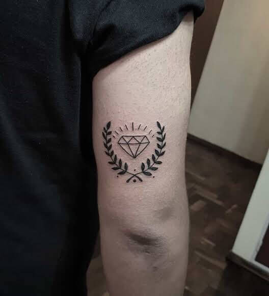 diamond with laurel leaves tattoo on upper arm for men