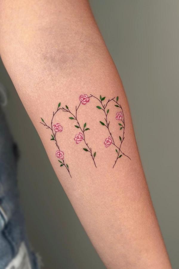pink flowers virgo sign tattoo design on forearm for females