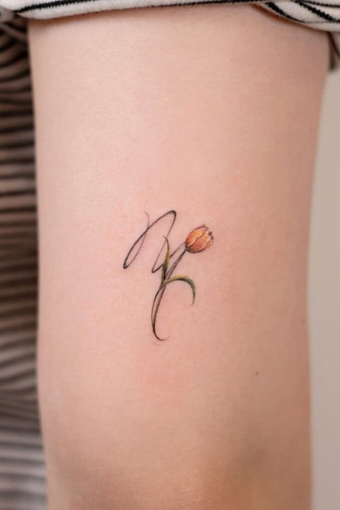 tulip flower with virgo sign tattoo on back arm for females