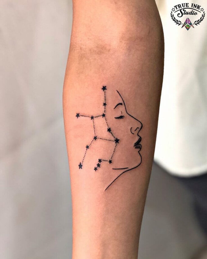 virgo stars constellation with female face tattoo design on forearm