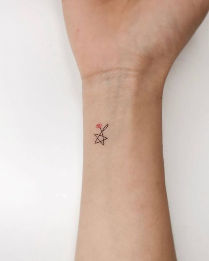 small star with flower tattoo design on wrist