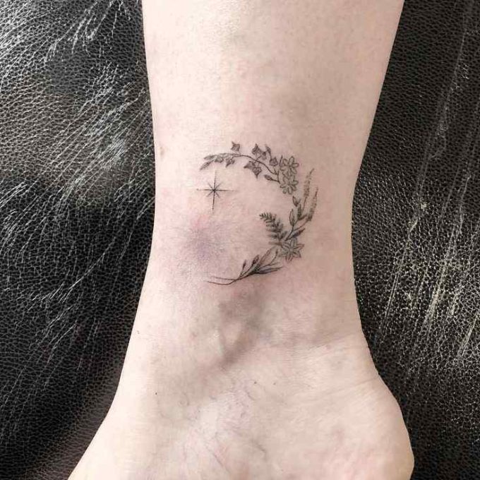 star with flower wreath tattoo design on ankle