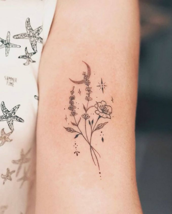 moon stars and flowers tattoo design on upper arm