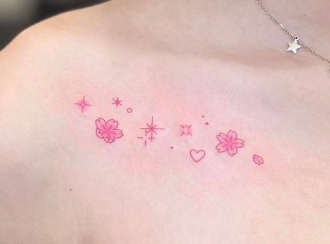 pink stars with flowers tattoo design on collarbone