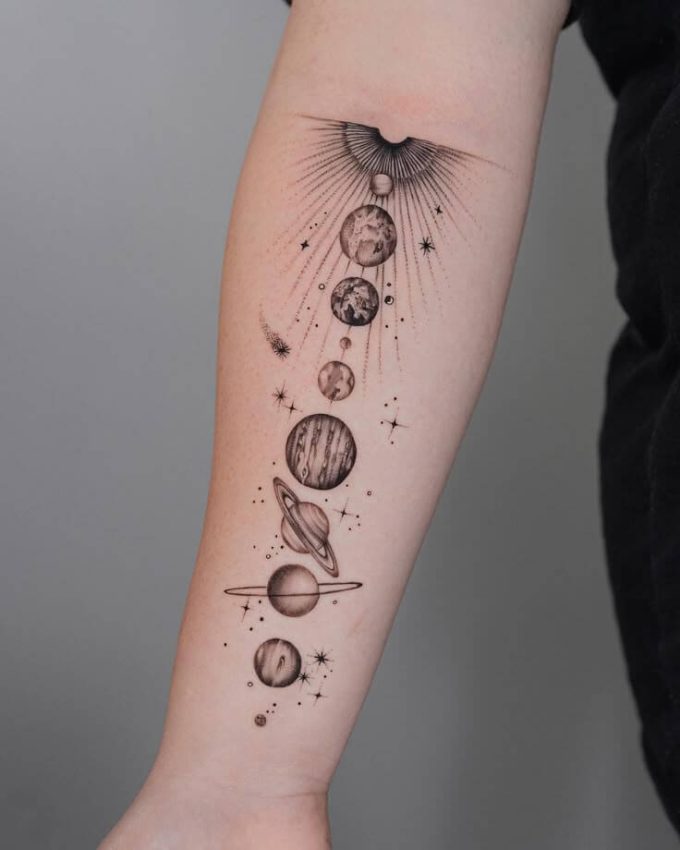 solar planets space themed tattoo design on forearm