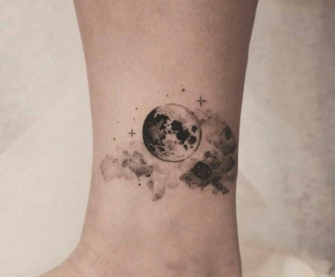 moon and clouds space themed tattoo design