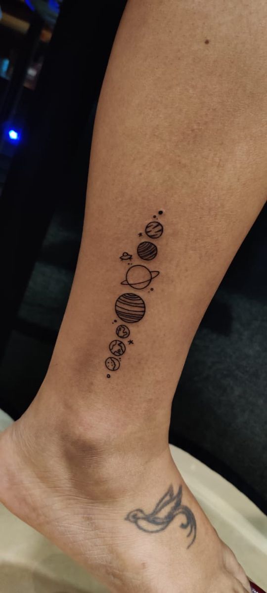 solar planets space themed tattoo design on lower side leg