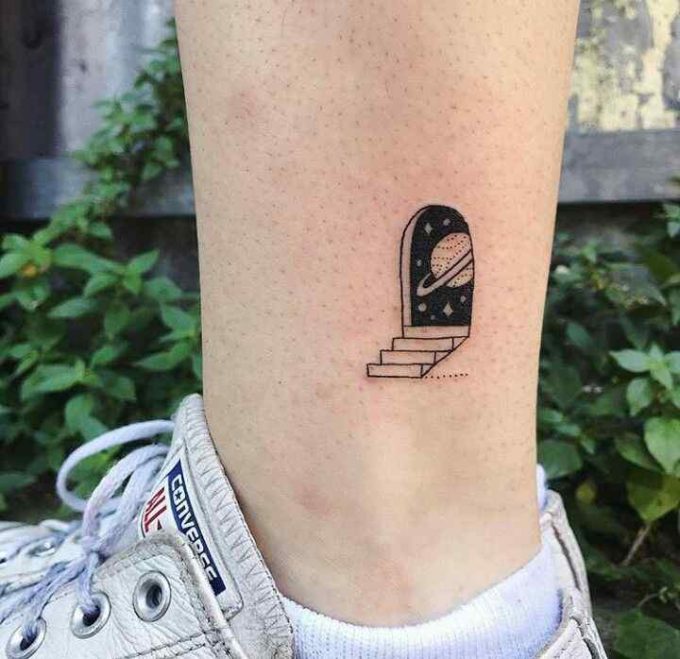 stairs to cosmos space themed tattoo design on ankle