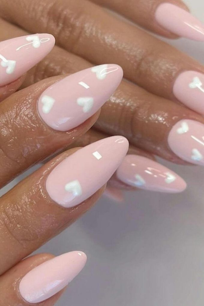 white hearts on pastel pink valentine nail designs